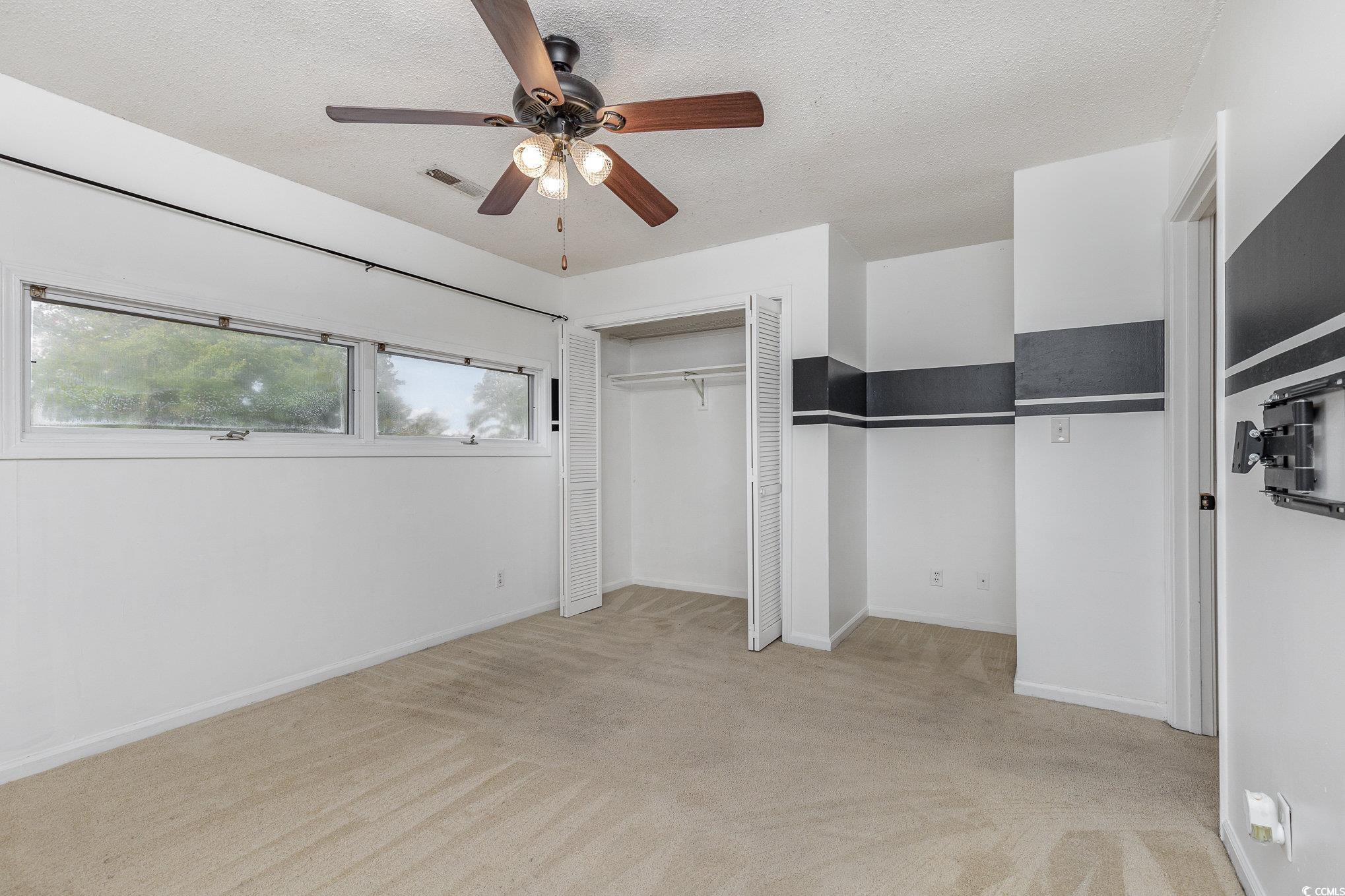 1830 Fairway Ridge Drive, Unit 6D Surfside Beach, SC 29575 - Photo 24 of 35 Bedroom featuring a closet, ceiling fan, light car