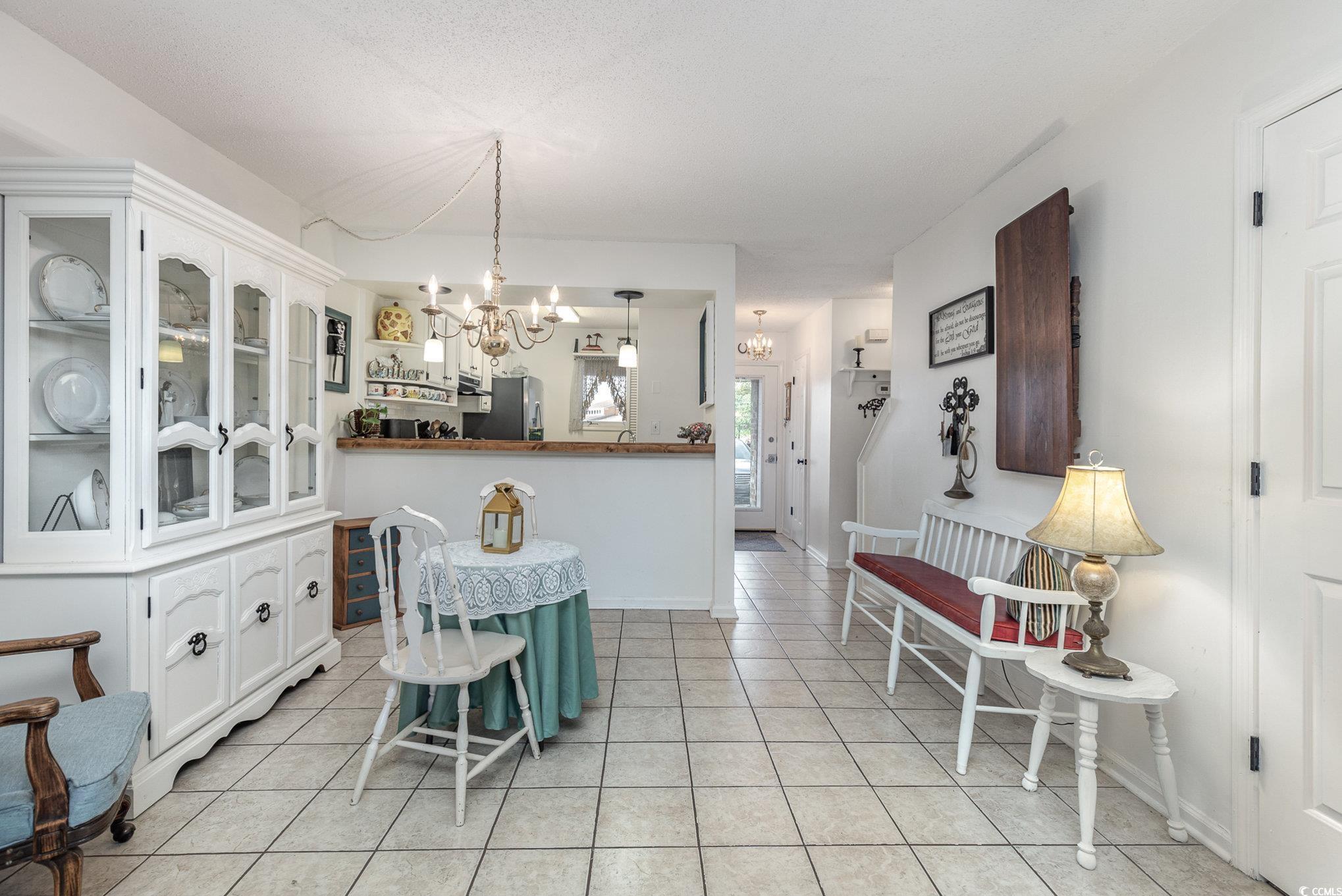 1830 Fairway Ridge Drive, Unit 6D Surfside Beach, SC 29575 - Photo 8 of 35 Dining space with a textured ceiling, a notable ch