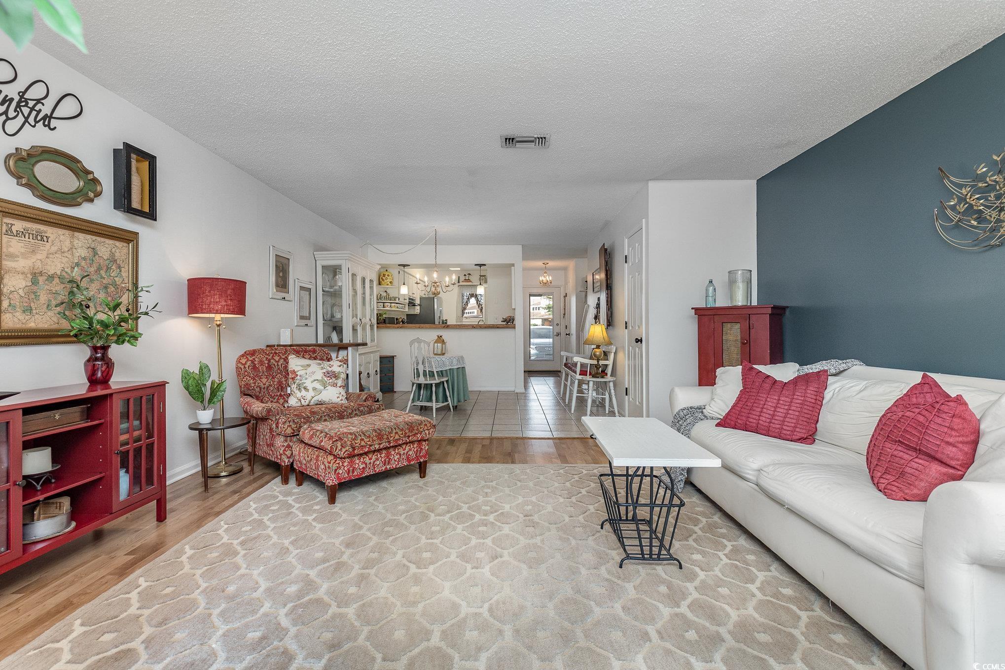 1830 Fairway Ridge Drive, Unit 6D Surfside Beach, SC 29575 - Photo 10 of 35 Living room featuring a textured ceiling, and wood