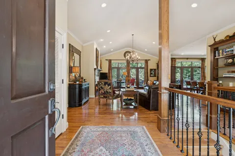 a living room with furniture large window and a fireplace