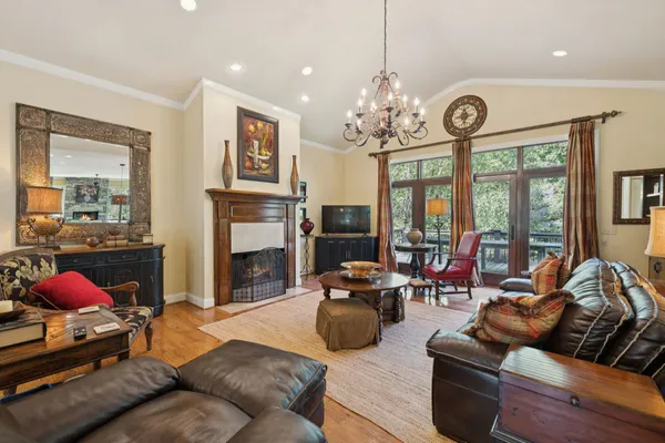 a living room with furniture large window and a fireplace