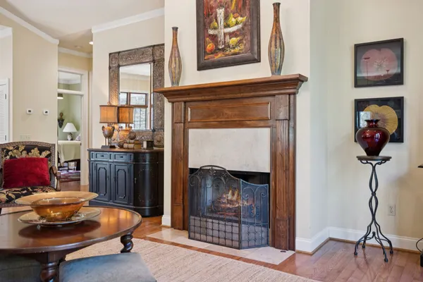 a living room with furniture a fireplace and a large window