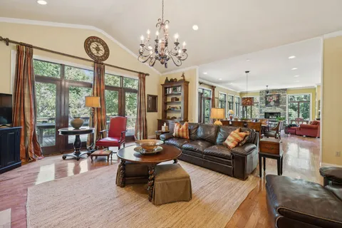 a kitchen with stainless steel appliances a dining table chairs stove and refrigerator