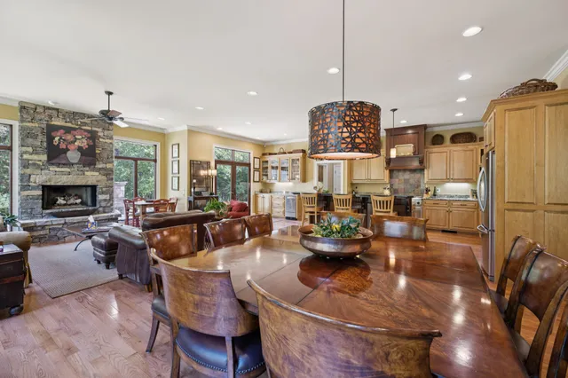 a kitchen with stainless steel appliances granite countertop a stove and a view of living room