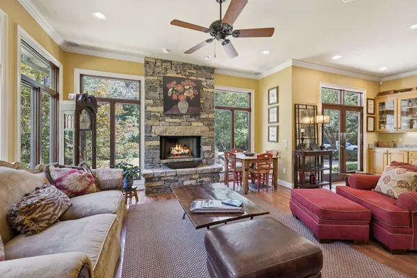 a kitchen with stainless steel appliances granite countertop a stove and a view of living room