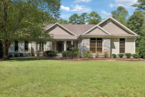 a front view of a house with a garden and porch