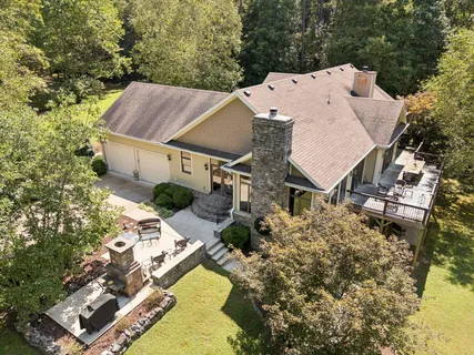 an aerial view of a house with a yard and trees