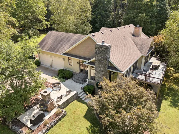 an aerial view of a house with a yard and trees