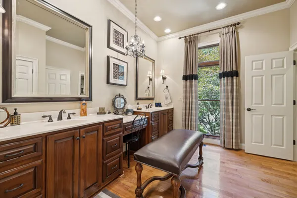 a spacious bedroom with two beds and a large mirror next to a window