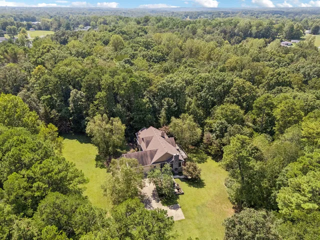 an aerial view of a house with a yard