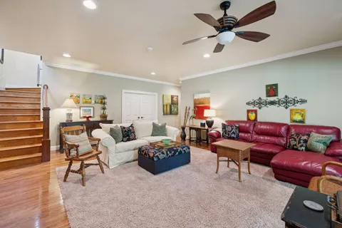 a open kitchen with granite countertop a stove top oven a sink and a wooden floor