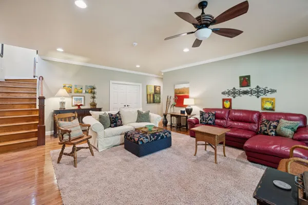 a living room with furniture and a wooden floor