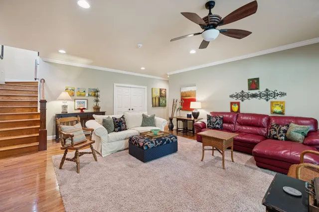a open kitchen with granite countertop a stove top oven a sink and a wooden floor