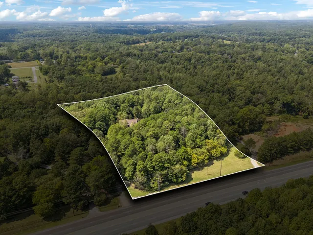 front view of a brick house with potted plants