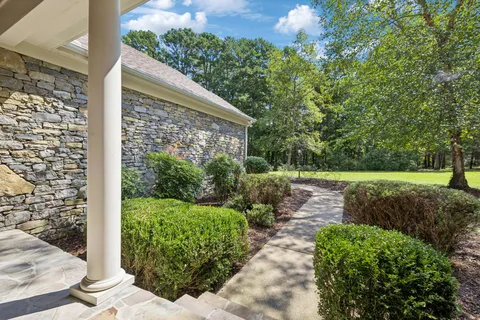 a living room with furniture a chandelier and a bookshelf