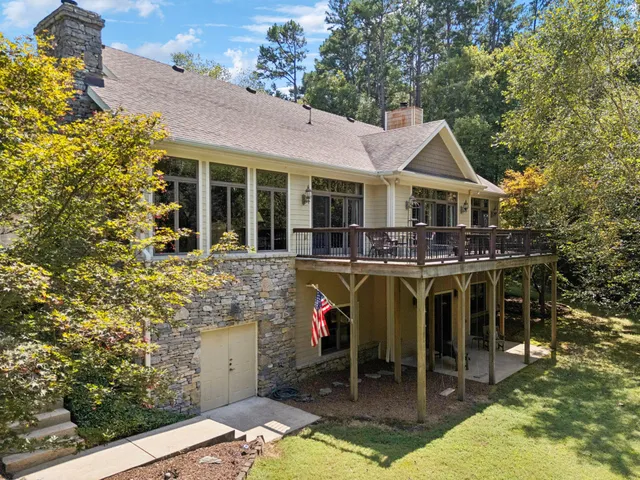 a living room with furniture large window and wooden floor