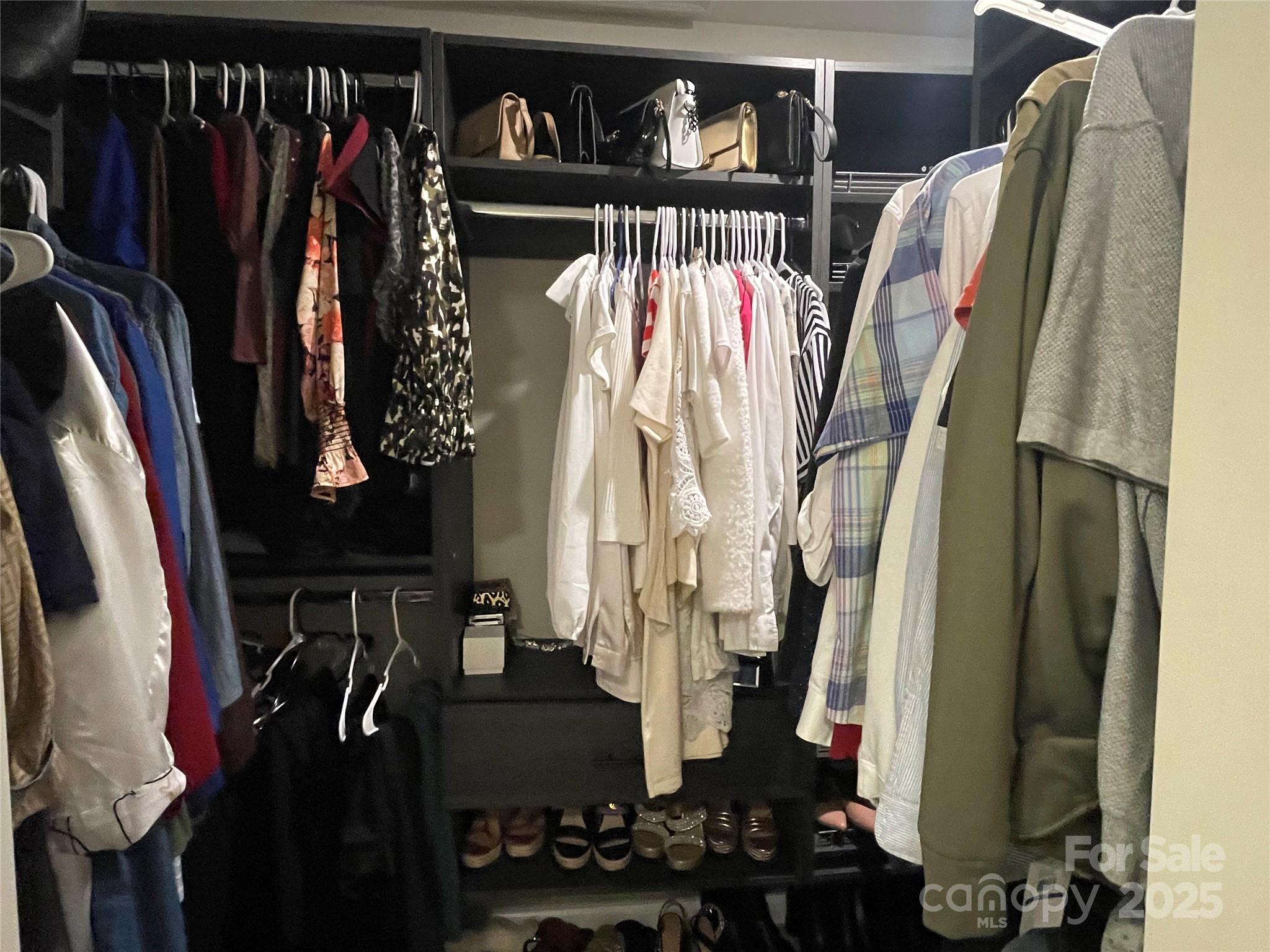 12417 Bryton Ridge Parkway Huntersville, NC 28078 - Photo 16 of 17 a view of walk in closet with clothes and shoes