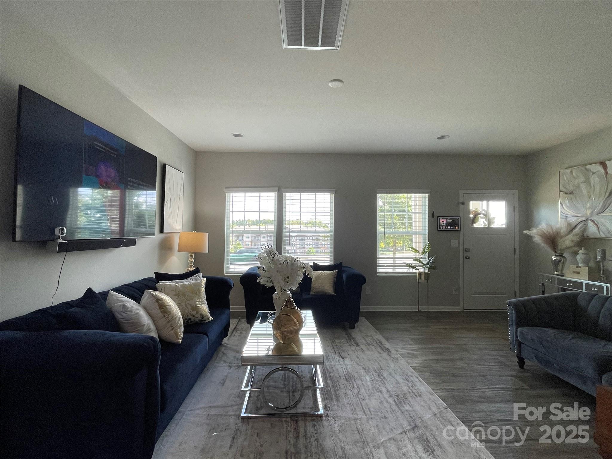 12417 Bryton Ridge Parkway Huntersville, NC 28078 - Photo 3 of 17 a living room with furniture wooden floor and a flat screen tv