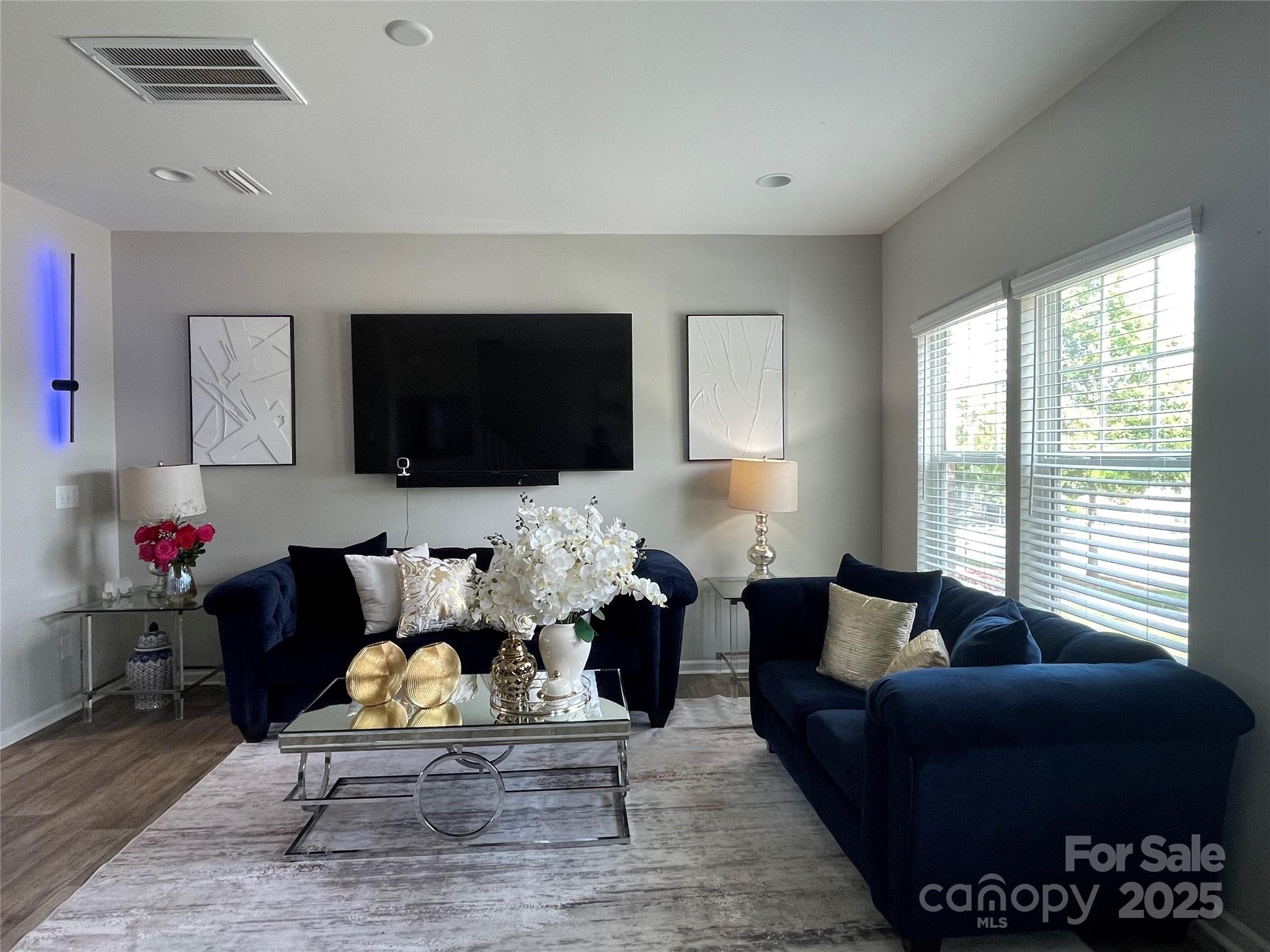 12417 Bryton Ridge Parkway Huntersville, NC 28078 - Photo 4 of 17 a living room with furniture wooden floor and a flat screen tv