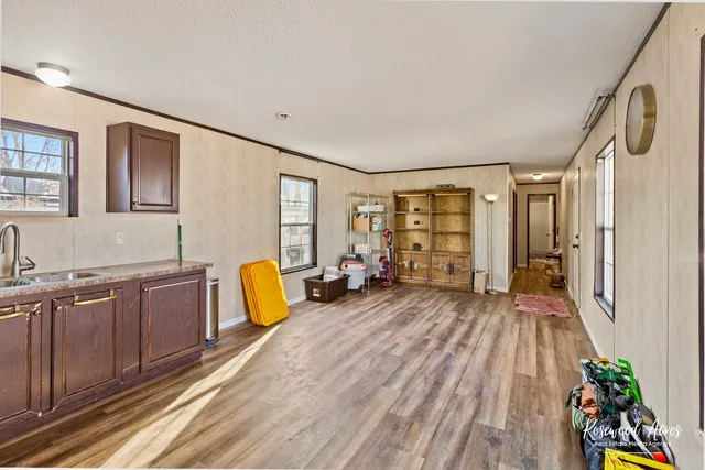 a view of a living room hardwood furniture and a kitchen
