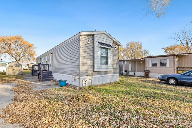 a view of a house with a yard covered in snow