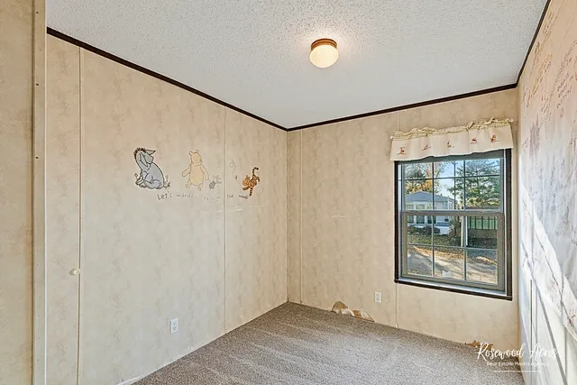 a view of a livingroom with wooden floor and a window