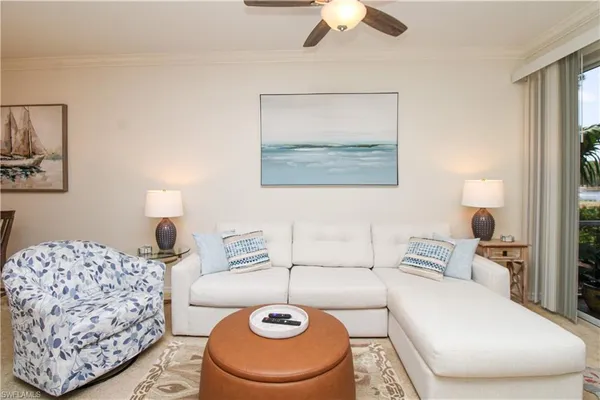 a living room with furniture and a lamp