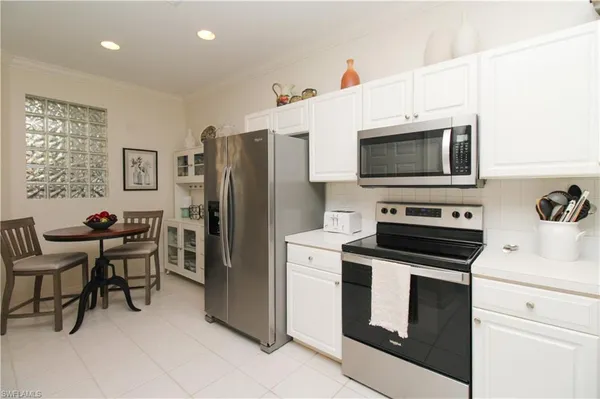 a kitchen with stainless steel appliances a stove microwave and refrigerator