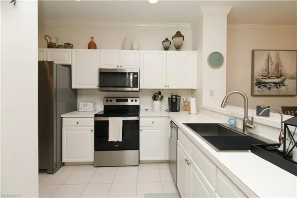 a kitchen with a sink and a stove top oven