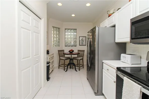 a kitchen with stainless steel appliances a refrigerator sink and microwave