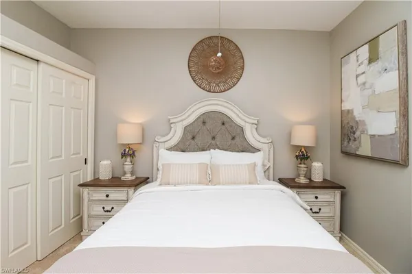 a bedroom with a bed and a painting on the wall