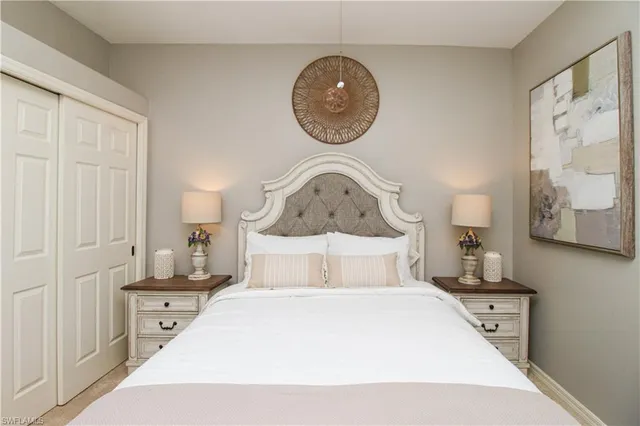 a bedroom with a bed and a painting on the wall