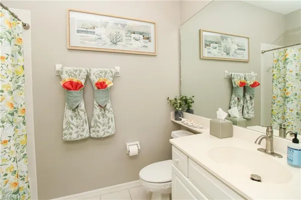 a bathroom with a sink mirror and toilet