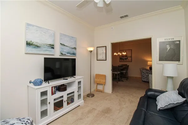 a view of a livingroom with furniture and a flat screen tv