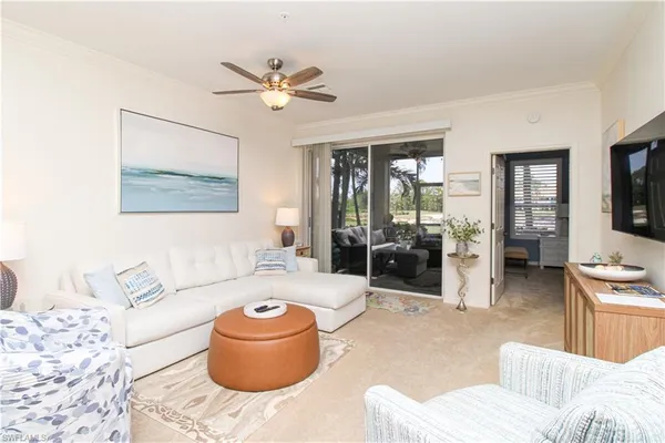 a living room with furniture and a chandelier
