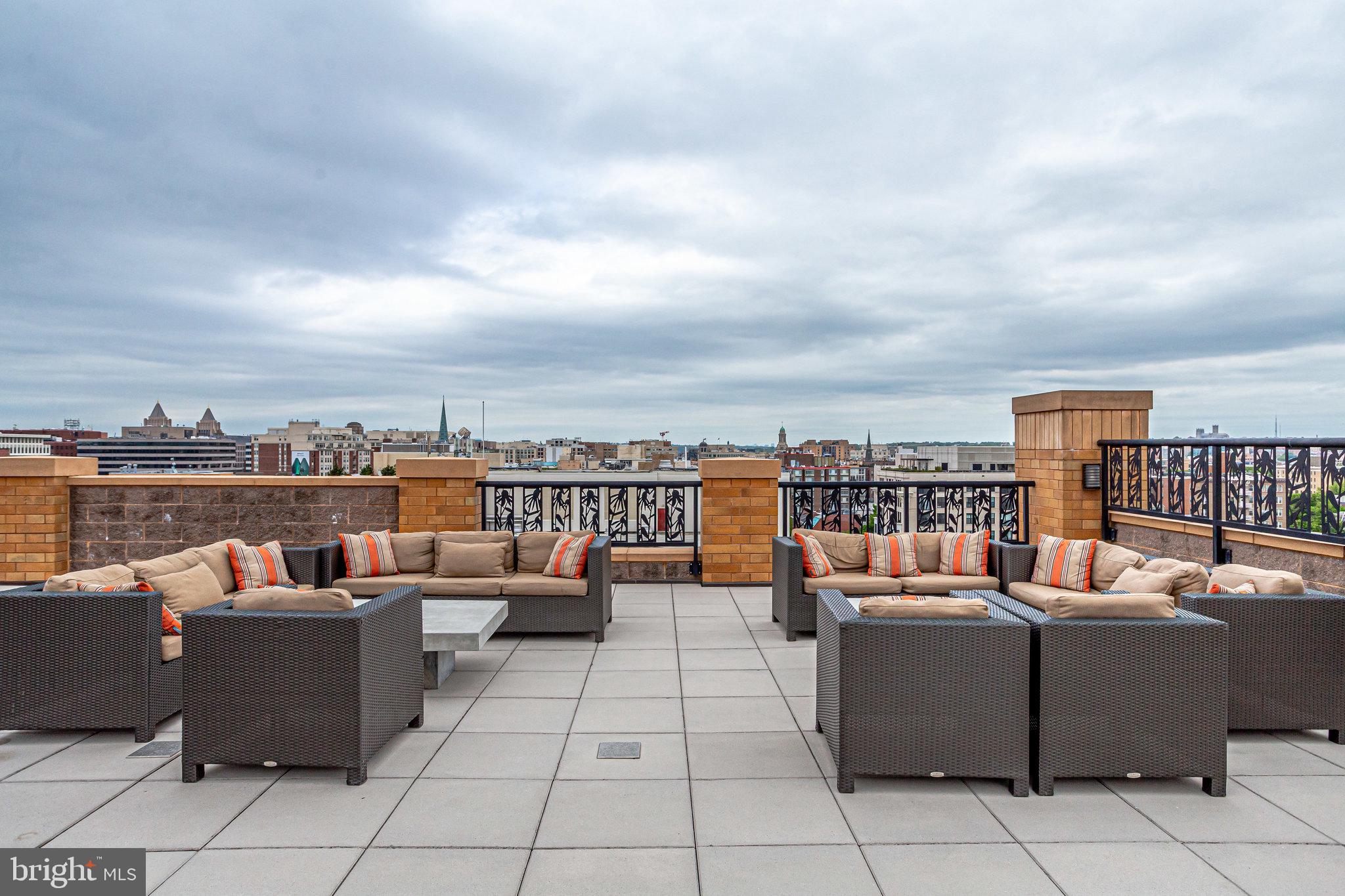 910 M Street Northwest, Unit 516 Washington, DC 20001 - Photo 23 of 28 a view of a roof deck with couches and potted plants