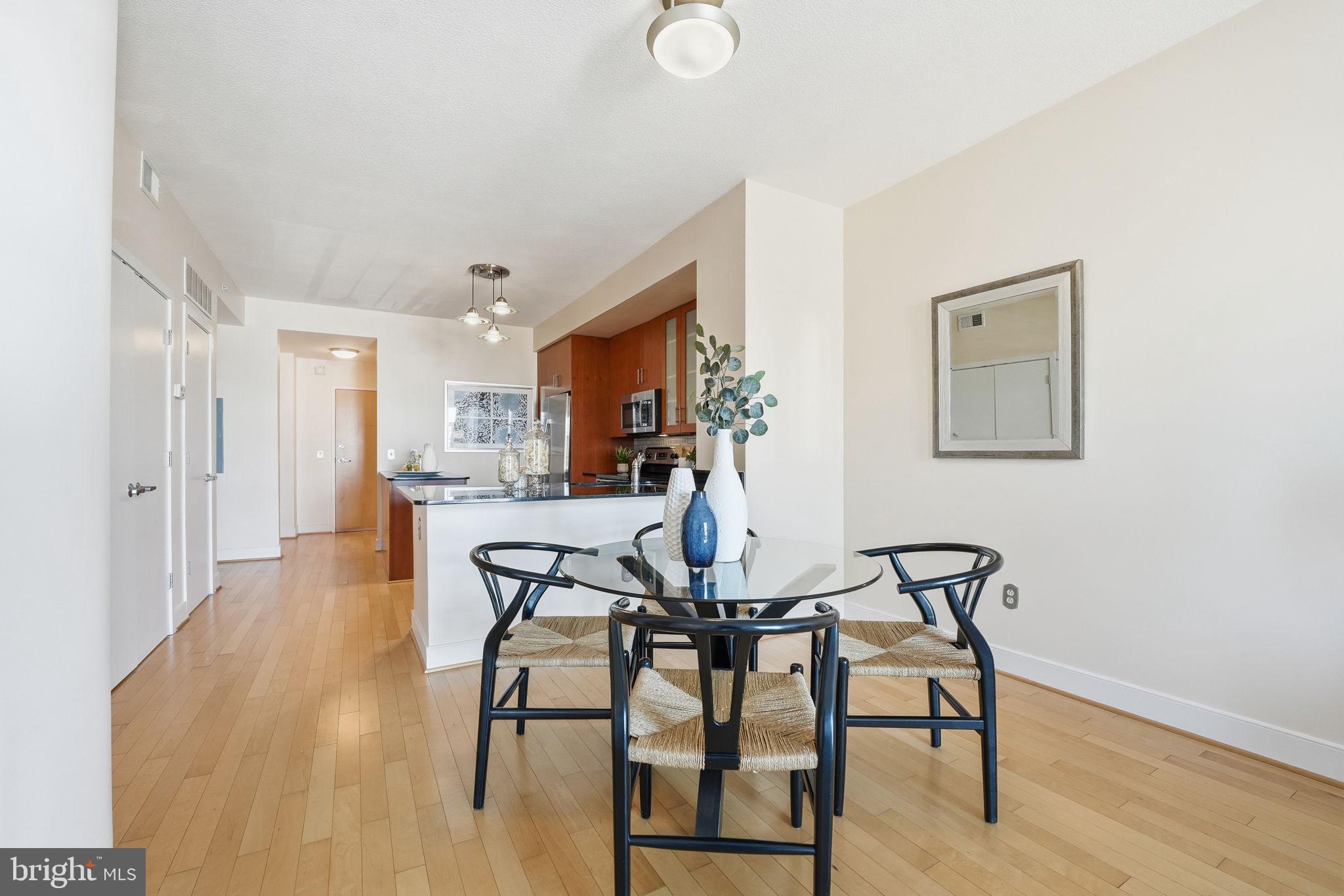910 M Street Northwest, Unit 516 Washington, DC 20001 - Photo 4 of 28 a view of a dining room with furniture and wooden floor