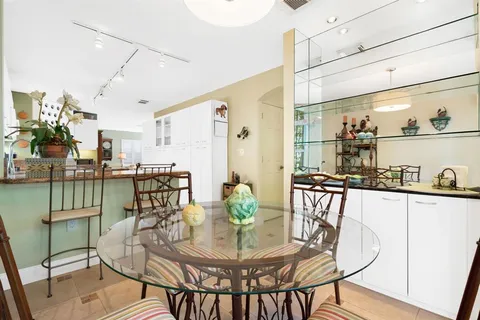 a dining room with furniture and wooden floor