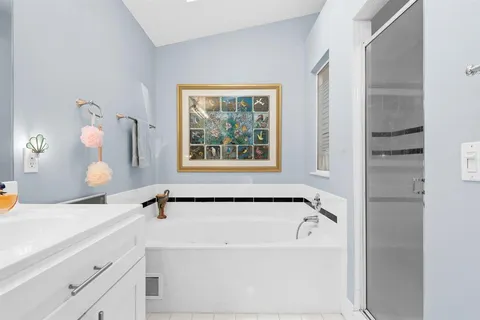 a bathroom with a bathtub and a sink