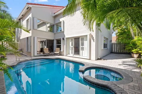 a view of house with swimming pool outdoor seating