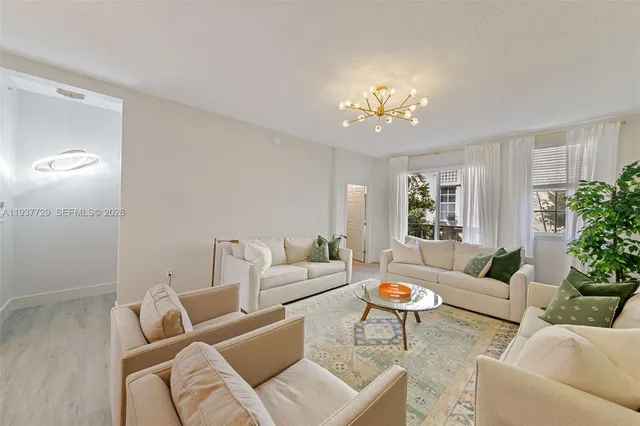 a living room with furniture and a chandelier