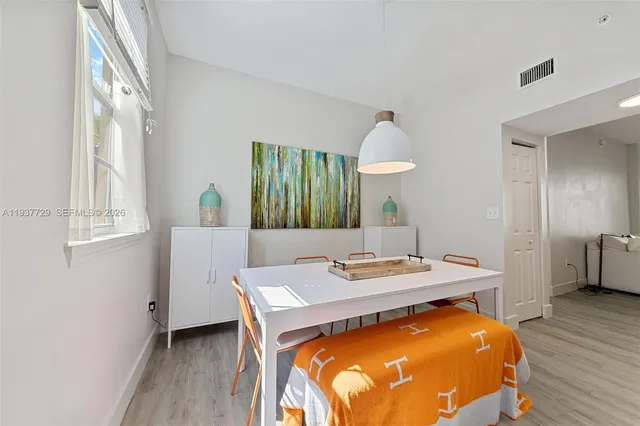 a view of a dining room with furniture and wooden floor