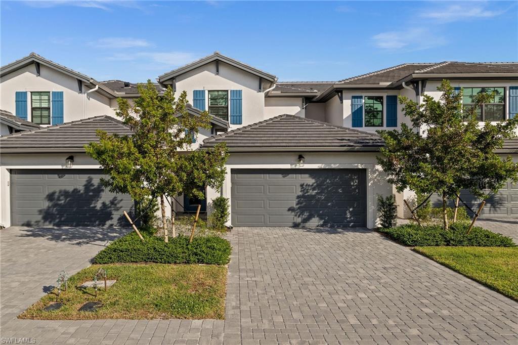 7640 Morgan Way Naples, FL 34119 - Photo 1 of 1 a front view of a house with a yard and garage