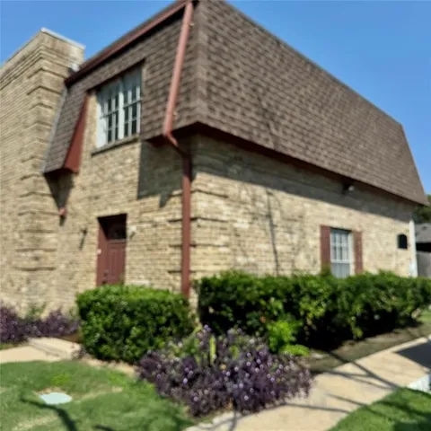 a brick building with a yard