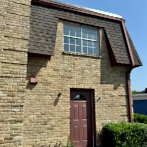 a front view of a house with brick walls