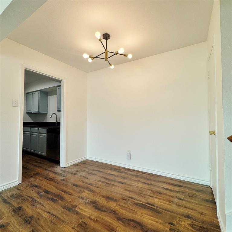 1809 East Grauwyler Road, Unit 133 Irving, TX 75061 - Photo 6 of 18 a view of empty room with wooden floor and fan