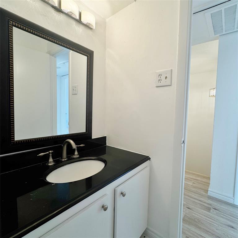 1809 East Grauwyler Road, Unit 133 Irving, TX 75061 - Photo 9 of 18 a bathroom with a sink and a mirror