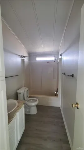 a bathroom with a toilet sink and shower