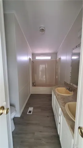 a bathroom with a tub a sink and mirror