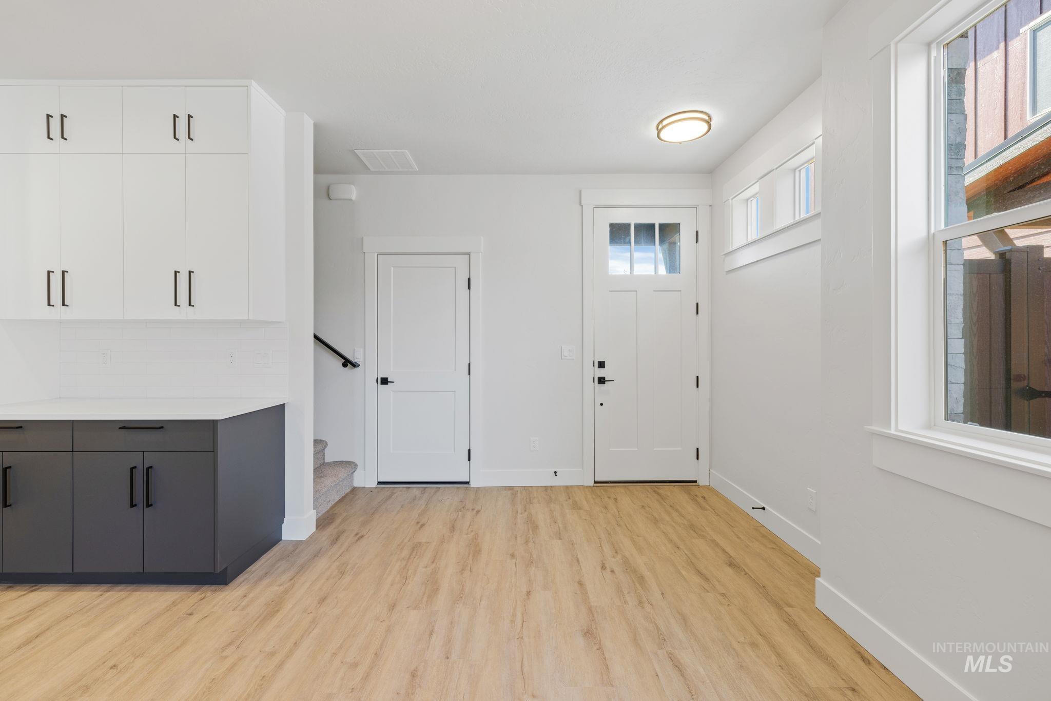 22 Bridger Street Cascade, ID 83611 - Photo 7 of 39 Entryway featuring light wood-style flooring and stairs